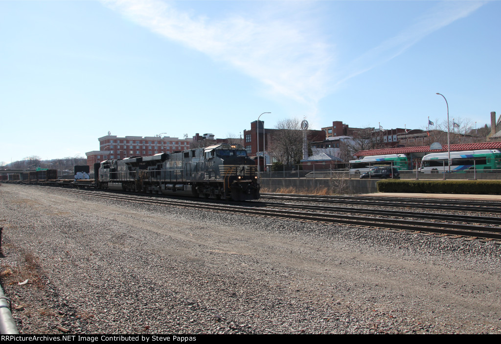 NS 7593 and 7637 take a train of flat cars east